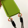 Close-up of green iPhone case showing strap attachment rings and woven lanyard detail.