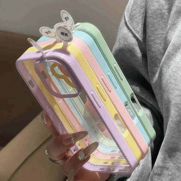 Stack of clear bumper iPhone cases in pastel purple, yellow, blue, and pink