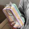Stack of clear bumper iPhone cases in pastel purple, yellow, blue, and pink