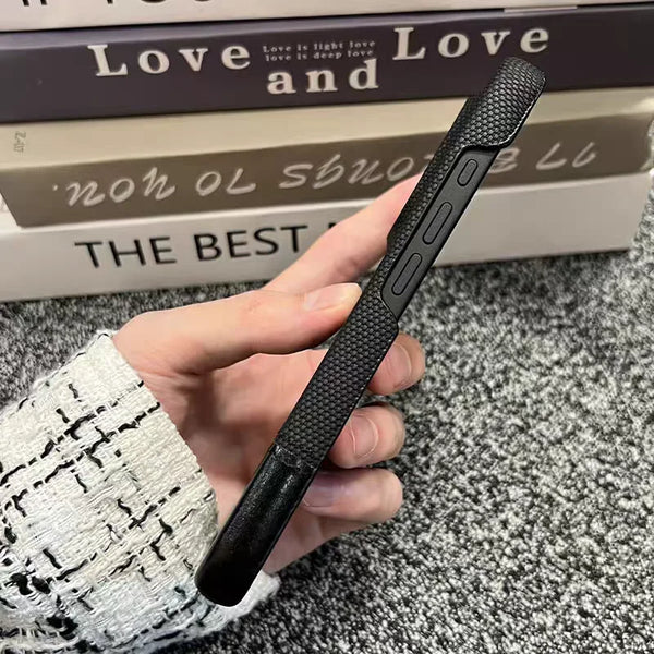 Side view of the black leather nylon iPhone case showing its slim profile and button cutouts.