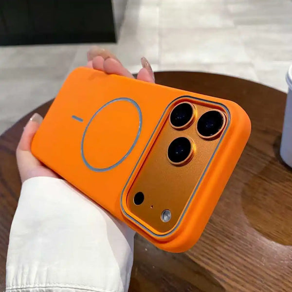 Orange matte iPhone case in hand showing the raised camera protection and magnetic ring design.
