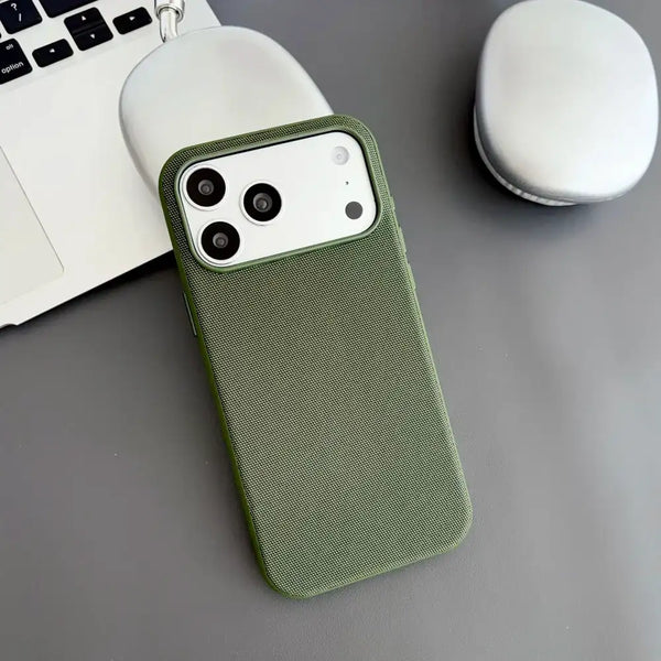 Green woven iPhone case highlighting the fabric-inspired surface and side buttons