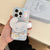 Hand holding the Cinnamoroll MagSafe Grip Case with visible camera protection