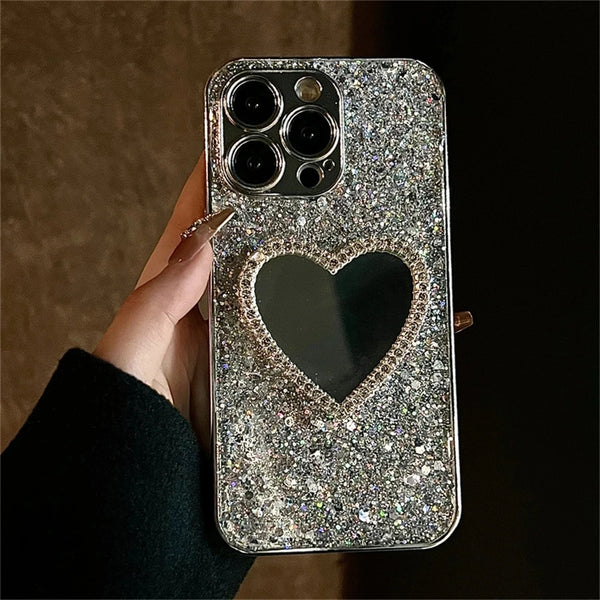 Close-up of silver heart mirror iPhone case with shimmering glitter finish