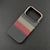 Carbon-inspired slim iPhone case with gold-toned camera frame and textured finish