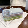 Stack of transparent iPhone cases in multiple pastel colorways