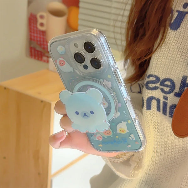 Clear iPhone case with pastel bear artwork and built-in stand held in one hand