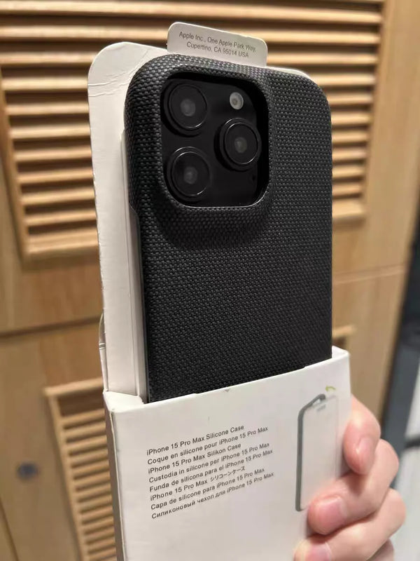 Black textured iPhone case displayed in packaging, highlighting the raised camera guard.