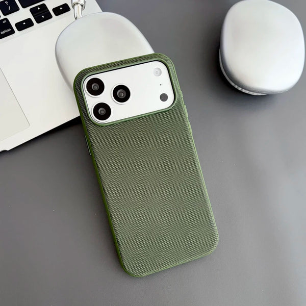 Green woven iPhone case highlighting the fabric-inspired surface and side buttons