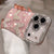 Pink translucent iPhone case with rhinestone butterflies and pearl accents, shown in hand.