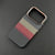 Carbon-inspired slim iPhone case with gold-toned camera frame and textured finish