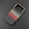 Carbon-inspired slim iPhone case with gold-toned camera frame and textured finish