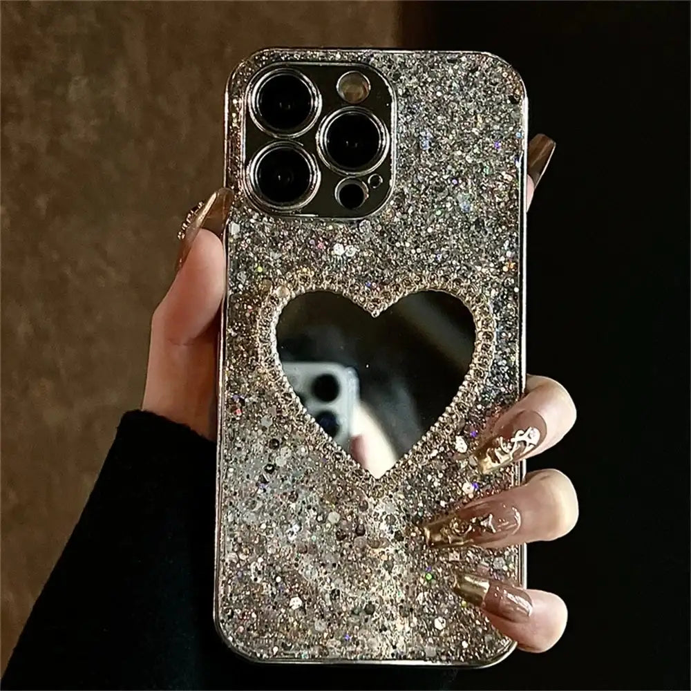 Silver glitter iPhone case with heart mirror cutout, held in hand