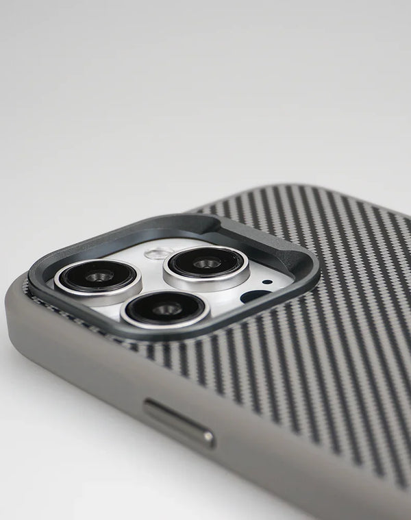 Camera module detail on the carbon-texture iPhone case with protective frame