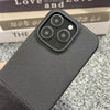 Black textured iPhone case showing the matte woven finish and raised camera opening.