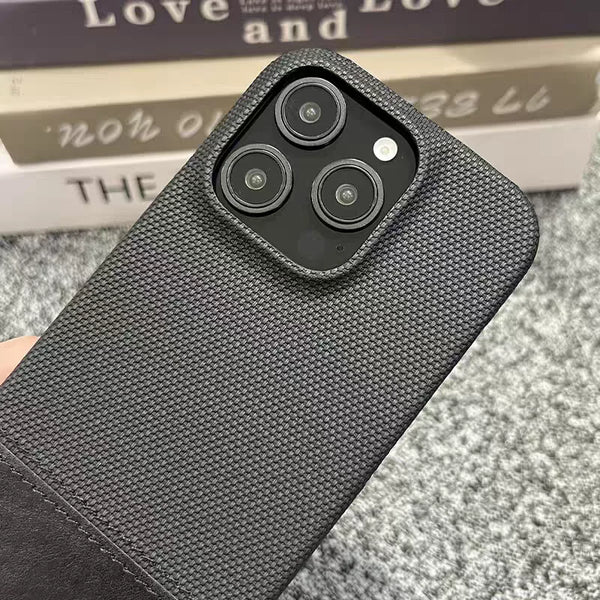 Black textured iPhone case showing the matte woven finish and raised camera opening.
