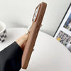 Brown woven iPhone case shown in hand with slim side profile and fabric texture