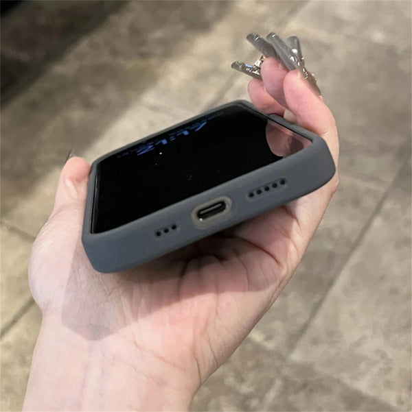 Dark gray liquid silicone iPhone case shown in hand with precise port cutouts and soft matte finish.