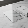 Premium tempered glass screen protector on marble surface showing ultra-thin profile