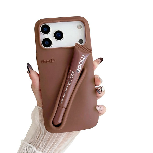 Trendora brown matte silicone iPhone case with built-in holder for Rhode lip gloss and raised camera protection.