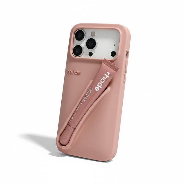 Trendora dusty rose matte silicone iPhone case with built-in holder for Rhode lip gloss and raised camera protection.